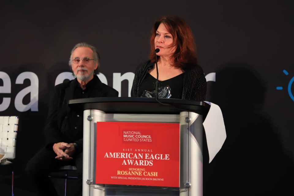 rosanne cash accepts the 2025 american eagle award at the namm show