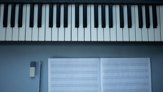 Electric piano and writing paper